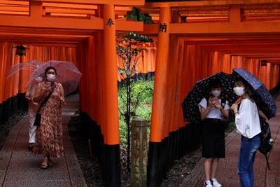 Tourists wear protective face masks at the Fushimi Inari Taisha shrine, one of Japan's most popular tourist destinations. Getty Images