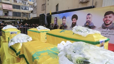 Supporters of Lebanon's Shiite Hezbollah movement gather around coffins of fighters of the group killed in Syria during their funeral procession in a suburb of the Lebanese capital Beirut. AFP