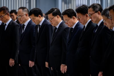 Hong Kong chief executive John Lee, fourth left, and other officials observe a minute of silence for victims of the Tai Po fire, on Saturday. EPA