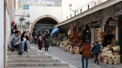 People walk in the Medina, in the old city of Tunis. The World Bank approved $300 million in financing to help the country's poor deal with the pandemic. Reuters