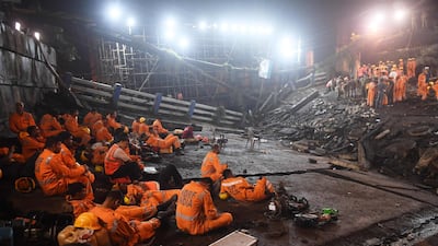 Rescue personnel take a break before continuing their duties. AFP