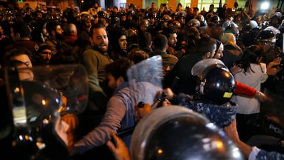 Riot police clash with protesters, as they try to remove them and open a road during an anti-government protest in Beirut, Lebanon. AP Photo