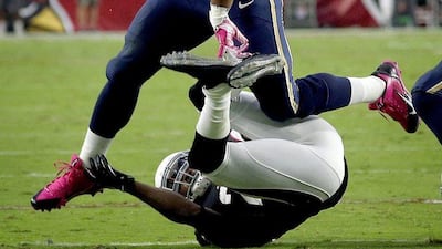 St Louis Rams running back Todd Gurley jumps over an Arizona Cardinals defender in his team's NFL victory last weekend. Ross D Franklin / AP / October 4, 2015