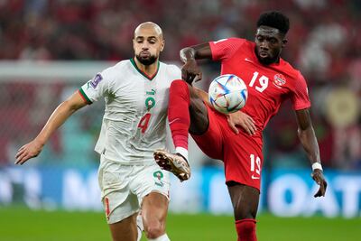 Morocco's Sofyan Amrabat, left, and Canada's Alphonso Davies, right, challenge for the ball. AP Photo