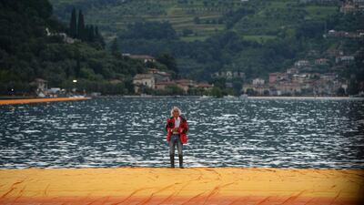 Christo walks on The Floating Piers on Lake Iseo, northern Italy on June 16, 2016. Filippo Monteforte / AFP Photo