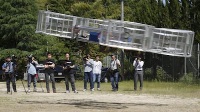 Tsubasa Nakamura, project leader of Cartivator, third from left, watches the flight of the test model of the flying car on a former school ground in Toyota, central Japan, Saturday, June 3, 2017. (AP Photo/Koji Ueda)