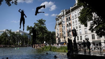 Paris residents cool off in the Canal Saint-Martin as temperatures in the city surge. AFP