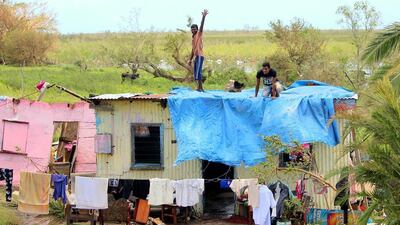 Residents repair a house following Cyclone Winston in Fiji’s western division. Fiji Government / AFP Photo