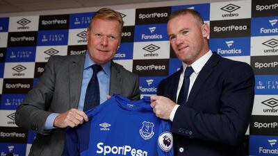 Wayne Rooney, right, poses with his Everton shirt alongside manager Ronald Koeman on Monday. Phil Noble / Reuters