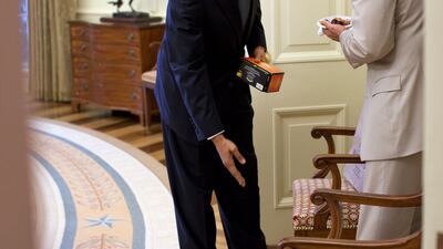Mr Obama jokingly scolds then-vice president Joe Biden for dropping birthday cake in the Oval Office of the White House. Photo courtesy of the National Archives