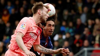 Eibar's Marc Cucurella, right, in action against FC Barcelona's Ivan Rakitic. EPA