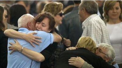 Relatives of earthquake victims hug each other during a funeral mass in Lorca, two days after a magnitude 5.1 quake killed nine people. Jorge Guerrero / AFP