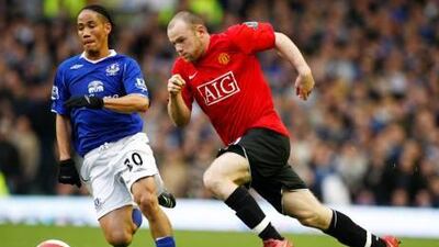 Manchester United's Wayne Rooney, right, chases a ball during an English Premier League match in Liverpool. A reader speculates on Rooney's fate after his playing days.