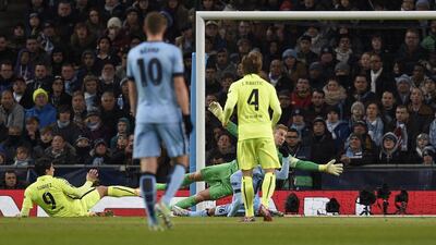 Barcelona's Luis Suarez scores his and his team's second goal against Manchester City on Tuesday night in their 2-1 Champions League last 16 first leg win. Lluis Gene / AFP