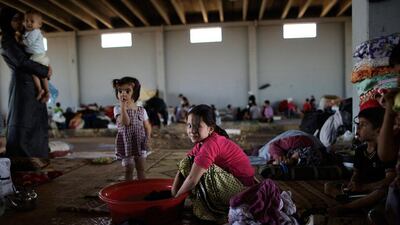 A Syrian girl, Wa'd Ismael, 8, centre, fled her home with her family in Marea 11 days ago due to Syrian government shelling of their neighborhood. She is seen washing her family's laundry as she and others take refuge at the Bab Al Salameh border crossing near the Syrian town of Azaz, in hopes of entering one of the refugee camps in Turkey. Muhammed Muheisen / AP Photo