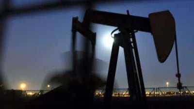 An oil pump works in the November moonlight in Bahrain oilfields.
