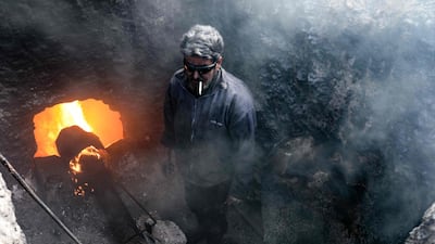 A man works at a makeshift oil refinery near the village of Tarhin. Many amateur refineries have sprung up in Syria since civil war broke out in 2011. AFP