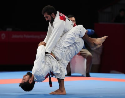 epa06973137 Adrian Guggenheim (bottom) of the Philippines in action against Saoud Al Hammadi of the United Arab Emirates (UAE) during the men's 77 kg Ju-Jitsu match of the 18th Asian Games Jakarta-Palembang 2018 in Jakarta, Indonesia, 26 August 2018. EPA/ADI WEDA