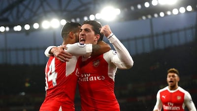 Arsenal's Theo Walcott, left, and Hector Bellerin celebrate a goal against Stoke City at the Emirates Stadium on December 10, 2016 in London, England. Clive Rose / Getty Images