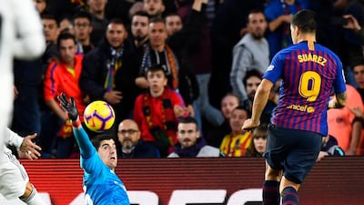 Barcelona's Uruguayan forward Luis Suarez scores his third goal during the Spanish league football match between FC Barcelona and Real Madrid CF at the Camp Nou stadium in Barcelona. AFP