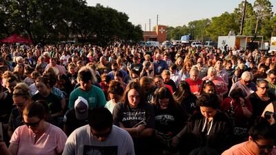 People listen to speakers at a vigil set up close to Santa Fe High School where a gunman shot numerous people in Santa Fe, Texas. Matt Patterson / EPA