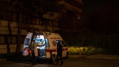 An ambulance is parked outside after transporting a new Covid-19 patient to the Living Place Hotel. Getty Images