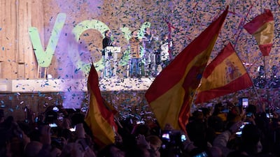 Supporters wave their flags during the final Vox party rally in Madrid on Friday. Getty Images