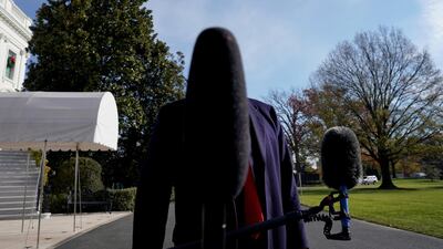 A microphone blocks the face of US President Donald Trump at the White House ahead of his trip to the G20 summit. Reuters