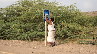 A member of the Tihama brigade hangs a flag for the Tihama Movement at the coastal front line where troops are advancing against the Houthi militias south of Hudayda, May 29, 2018. Asmaa Waguih for The National