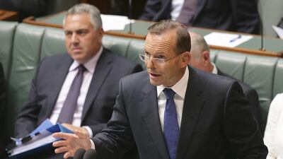 Australia's Prime Minister Tony Abbott speaks about the nation's new anti-extremism strategy during a question time at Parliament House in Canberra, Australia, Monday, Feb. 23, 2015. Australia will strengthen immigration laws and crack down on groups that incite hatred under a raft of counterterrorism measures introduced Monday in a bid to combat the threat from home-grown terrorists.(AP Photo/Rob Griffith)