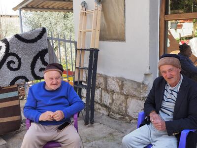 Two men relax in the courtyard of Beit Judoodna. Emily Lewis for The National