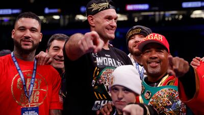 Tyson Fury celebrates with his team and son after beating Derek Chisora. Reuters