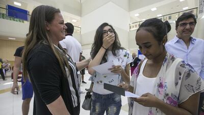 Al Yasmina Academy pupils and their families check out the GCSE results. Mona Al Marzooqi / The National
