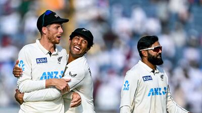 New Zealand's Mitchell Santner is embraced by teammate Rachin Ravindra as they celebrate after their 113-run win against India in the second Test in Pune on October 26, 2024. Santner took 13 wickets in the match to give the Black Caps an unassailable 2-0 lead in the series. AFP