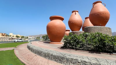 A collection of Arab pots decorate another roundabout in Dibba.