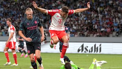 Bayern's goalkeeper Sven Ulreich collects the ball as Manchester City's Erling Haaland closes in and Bayern's Josip Stanisic covers. AP
