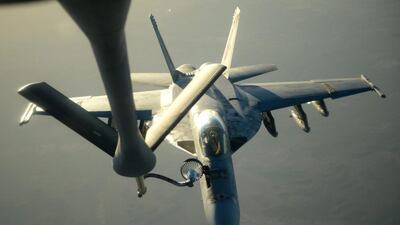 A handout picture from the US department of defence shows a US navy F-18E Super Hornet refueling from a KC-135 Stratotanker over northern Iraq after conducting air strikes in Syria. US Air Force/EPA