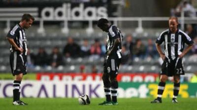 Newcastle look down in the dumps after conceding a second goal against Spurs.
