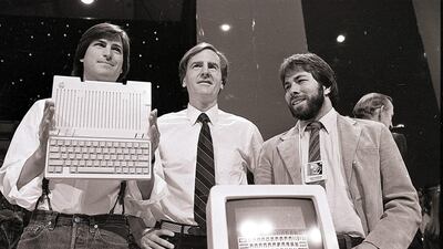 In this April 24, 1984 file photo, Steve Jobs, left, chairman of Apple Computers, John Sculley, center, then president and CEO, and Steve Wozniak, co-founder of Apple, unveil the new Apple IIc computer in San Francisco. (AP Photo/Sal Veder, File)