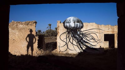 A mural by Belgian artist Roa decorates an abandoned wall. Joel Saget / AFP Photo
