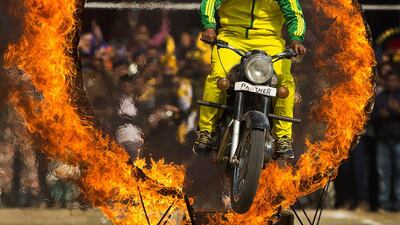 A member of Assam's police force jumps through a ring of fire in Gauhati. Anupam Nath / AP Photo