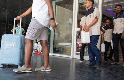 Residents move out of the high-rise building that caught on fire on Thursday night. Leslie Pableo for The National