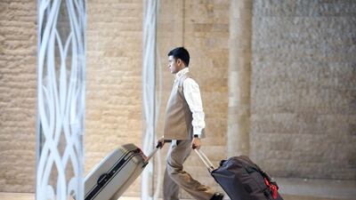A porter hurries suitcases thought the lobby at the Sofitel The Palm hotel at the Palm Jumeirah in Dubai. Strong hotel bookings for the festive period have been recorded. Silvia Razgova / The National
