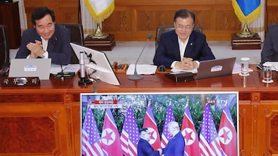 South Korean President Moon Jae-in and Prime Minister Lee Nak-yon watch a television screen showing the summit between US President Donald Trump and North Korean leader Kim Jong Un during a Cabinet meeting at the presidential Blue House in Seoul. Yonhap / AFP