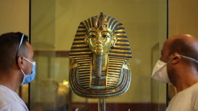 Tourists look at the golden mask of ancient pharaoh king Tutankhamen as they visit the Egyptian Museum at Tahrir Square. Reuters