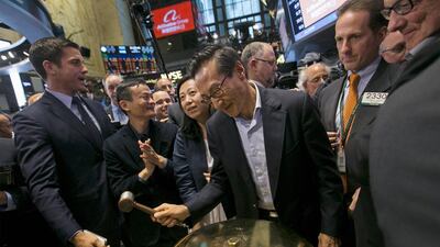 Joseph Tsai, vice chairman and co-founder of Alibaba, rings a ceremonial bell at the New York Stock Exchange to celebrate the company’s initial public offering. Brendan McDermid / Reuters