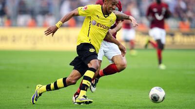 Dortmund's Gabonese striker Pierre-Emerick Aubameyang and Hanover's Danish midfielder Leon Andreasen vie for the ball during their Bundesliga match in Dortmund on October 19, 2013. Patrik Stollarz / AFP