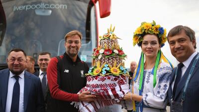 A handout photo made available by the UEFA of Liverpool's manager Juergen Klopp (C-L) receiving a gift as he arrives ahead of the UEFA Champions League final at IEV Airport in Kiev, Ukraine. EPA / UEFA / HANDOUT
