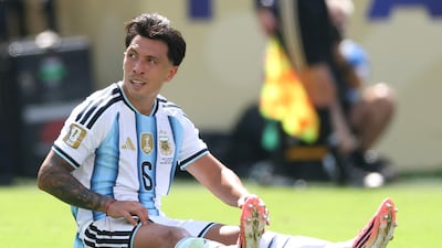 Argentina's Lisandro Martinez sits down on the ground before limping off injured in the first-half. AFP