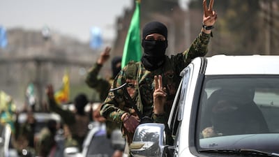 Kurdish forces leave the city of Aleppo on Wednesday as part of an agreement with the Syrian government. EPA